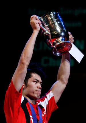 China's Lin Dan holds up the trophy after beating China's Chen Yu in the men's single final match at the All England badminton championships in Birmingham, England March 11, 2007.