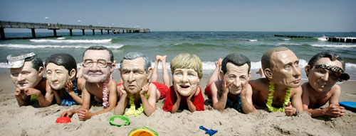 Activists of British charity organization Oxfam, wearing masks of the G8 heads of state, pose on the beach in Kuehlungsborn June 7, 2007. Leaders from the world's major industrialised nations meet in the Baltic resort of Heiligendamm on June 6-8 for a Group of Eight (G8) summit.