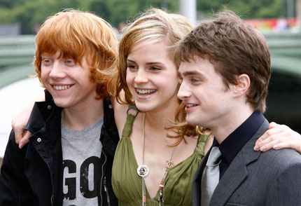 Actors Daniel Radcliffe (R), Rupert Grint (L), and Emma Watson pose during a photocall to promote the new film 