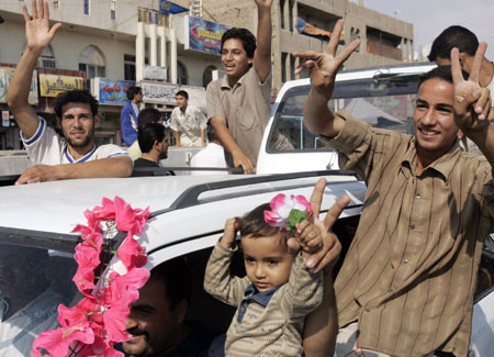 Shi'ite residents take to the streets in reaction to the verdict against former Iraqi leader Saddam Hussein, in Baghdad's Sadr city, November 5, 2006. Saddam was found guilty on Sunday of crimes against humanity and sentenced to hang in a case involving the deaths of more than 148 Shi'ite men from the town of Dujail. 