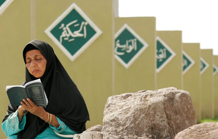 A mother prays for her family members, who were killed during the Indian Ocean tsunami two years ago, at a mass cemetery in Banda Aceh December 26, 2006.