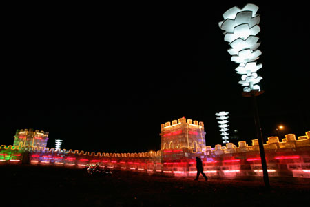 A man walks along an ice sculpture modelled after the Great Wall of China for the upcoming the China Harbin international ice and snow festival in Harbin, northeastern China's Heilongjiang Province, January 4, 2007.