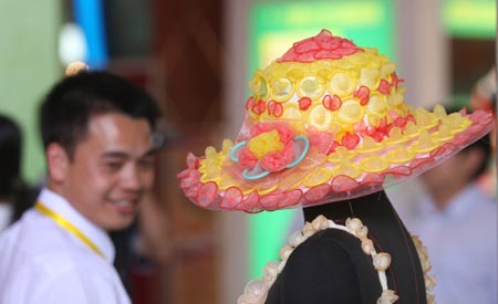 A man looks at an outfit made of condoms during a fashion show at the 4th China Reproductive Health New Technologies & Products Expo in Beijing July 11, 2007. Condoms of all shapes and sizes were on show at a Beijing fashion show on Wednesday featuring dresses, hats and even lollipops made of the said item.