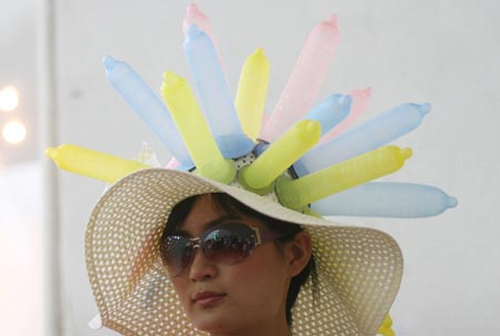 A model parades an outfit made of condoms during a fashion show at the 4th China Reproductive Health New Technologies & Products Expo in Beijing July 11, 2007. Condoms of all shapes and sizes were on show at a Beijing fashion show on Wednesday featuring dresses, hats and even lollipops made of the said item. 