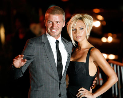 Los Angeles Galaxy's David Beckham waves beside his wife Victoria at a party at the Museum of Contemporary Art in Los Angeles July 22, 2007. Actor Tom Cruise and his wife Katie Holmes hosted a party for the Beckhams on Sunday.