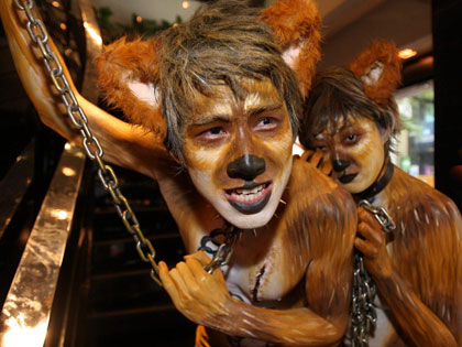 Animal rights activists, dressed up as dogs, attend a protest against the eating of dog meat in central Seoul July 25, 2007. In the summer, many Koreans traditionally eat dog meat for good health to overcome hot weather.