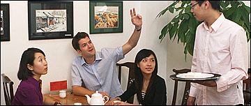 A group of people order food at a restaurant