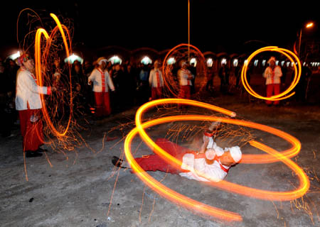 People play with fireworks in Nanjie village of Taiyuan, capital of northern China