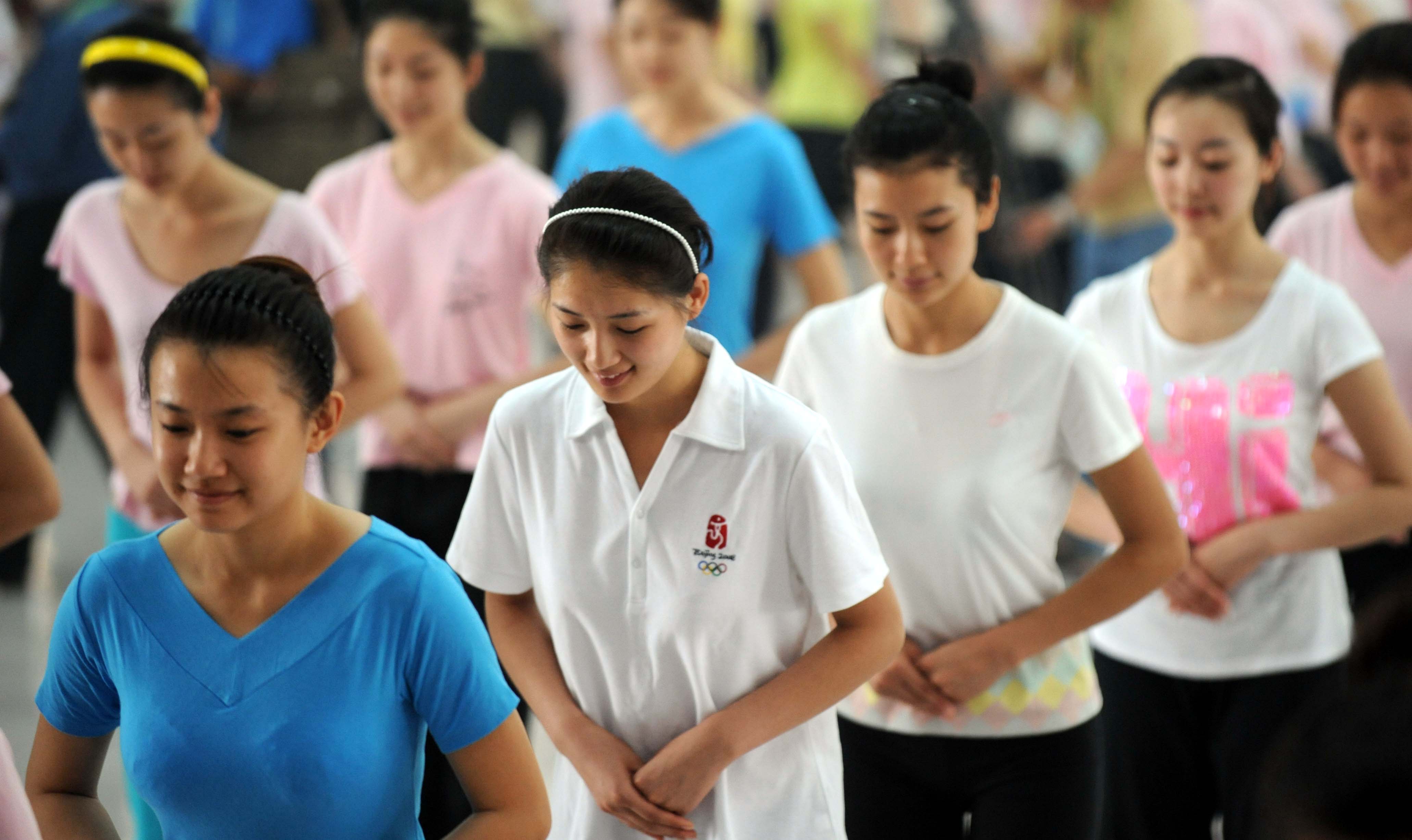 Olympic medal ceremony hostesses train for the coming Games