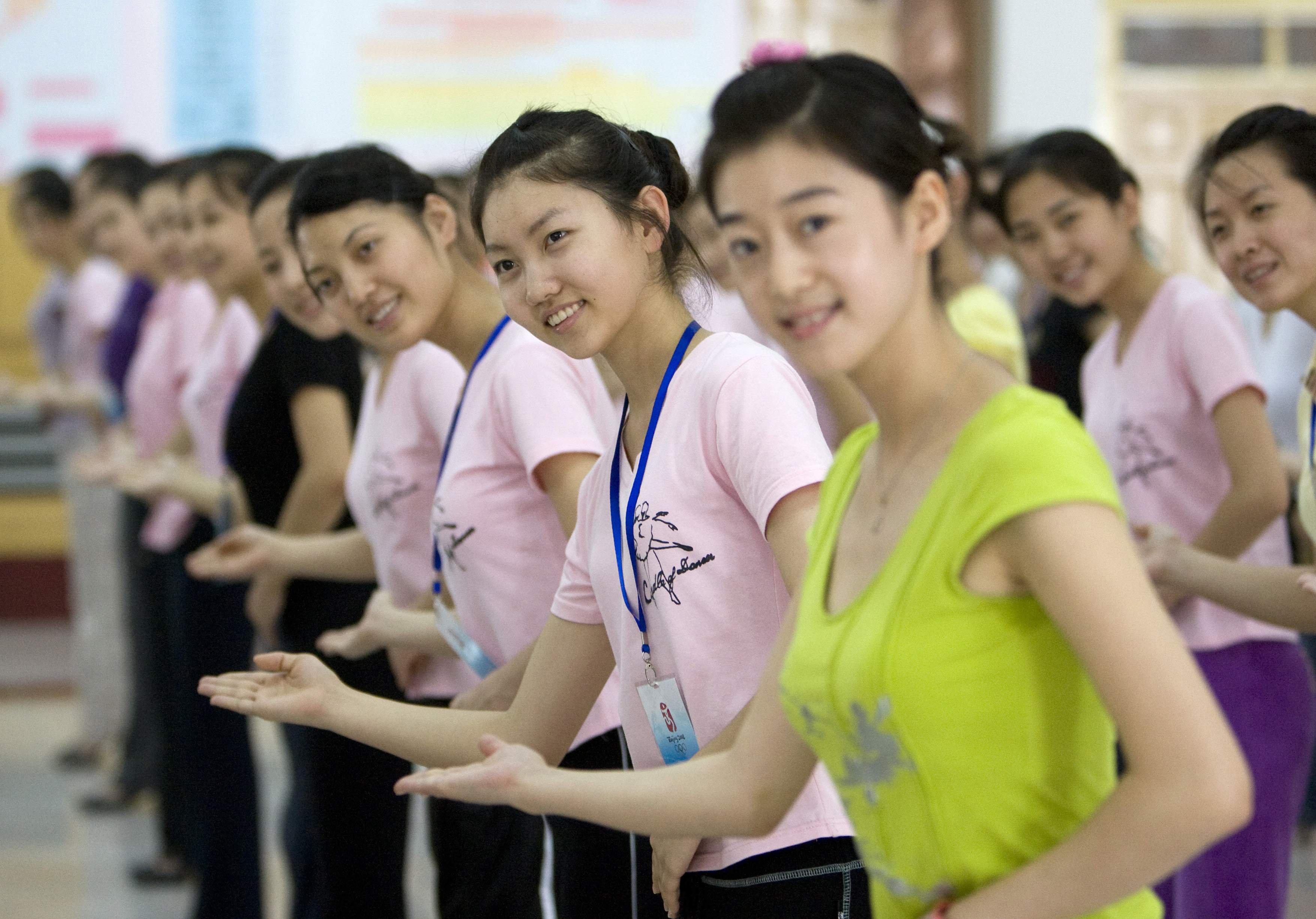 Olympic medal ceremony hostesses train for the coming Games