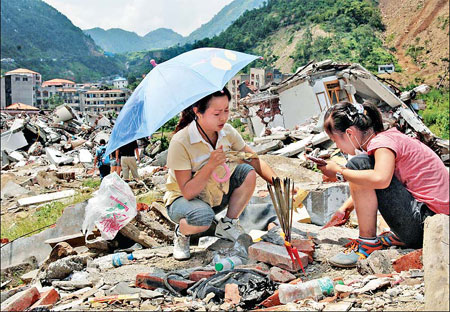 100 days after killer quake, people remember and rebuild