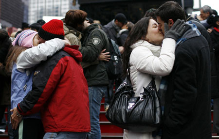 Couples practice kissing for New Year's Eve celebration