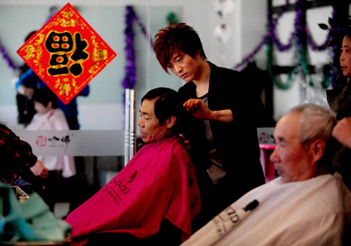 A child gets a haircut at a barbershop in Hefei